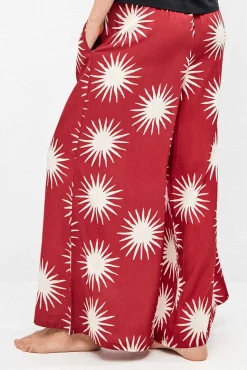 Calça comprida perna larga com estampado de sóis