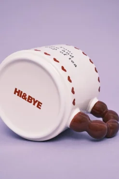 Caneca cerâmica bege com alça de bolas